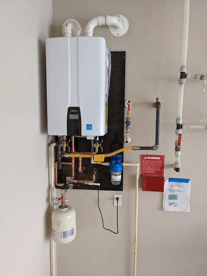 Professional plumber installing copper piping in a Dallastown home